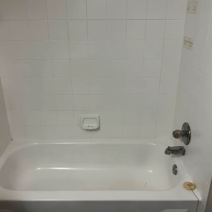 a bathtub and tiled surround, after cleaning by Brio Cleaning